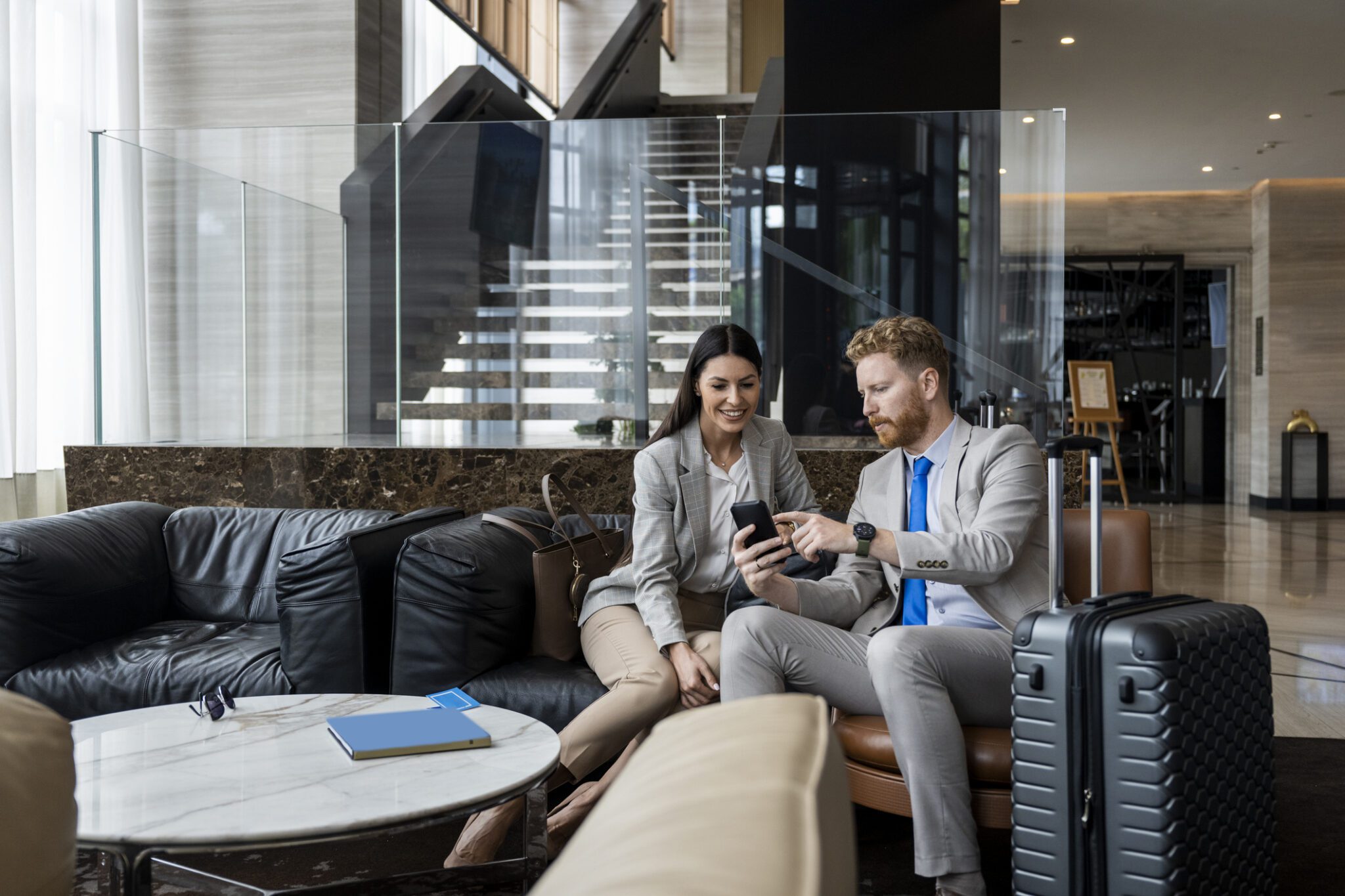 Business colleagues in hotel lobby with suitcase