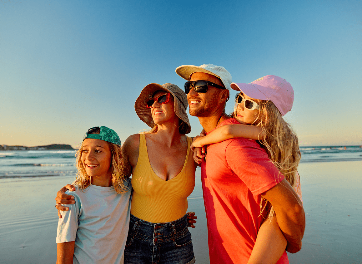 Happy family posing by the ocean