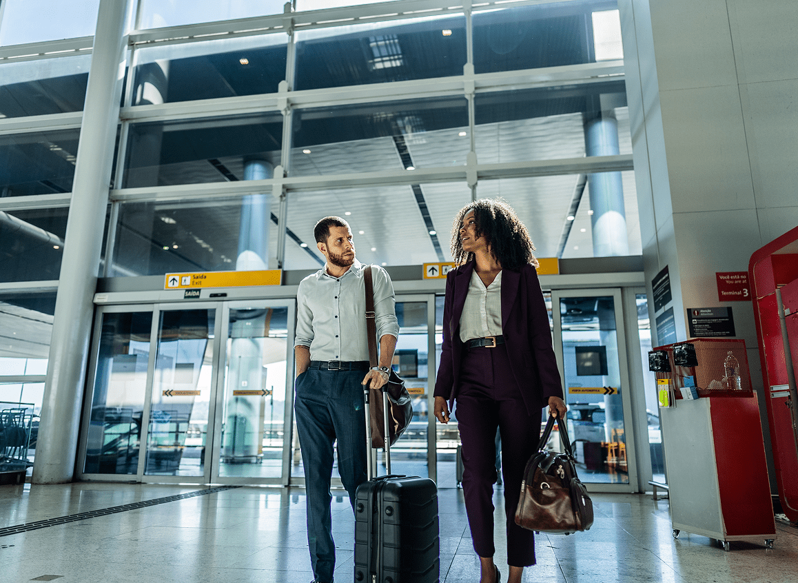 Business professionals with luggage at airport