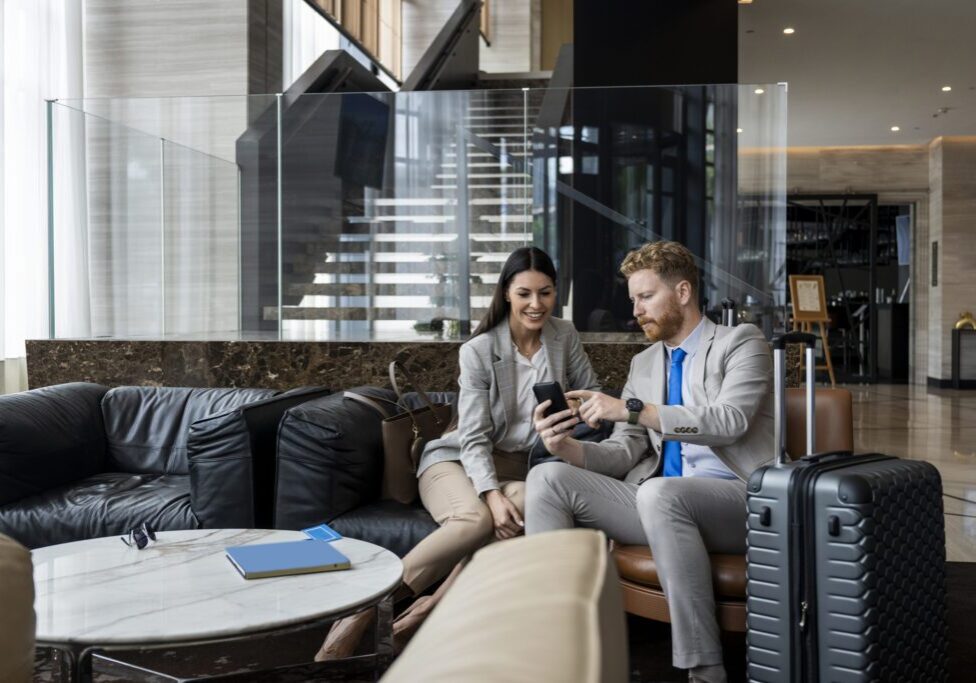 Business colleagues in hotel lobby with suitcase